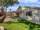 Expansive backyard featuring a covered patio, mature landscaping and lush artificial turf at 1195 Sunfire St, Henderson, NV 89014