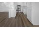 Clean white kitchen featuring new stainless steel appliances and wood-look floors at 1195 Sunfire St, Henderson, NV 89014