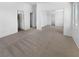 Spacious living area features neutral carpet, natural light, and multiple entryways at 1195 Sunfire St, Henderson, NV 89014