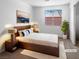 Cozy staged bedroom with ample light, plush carpet, and a large window at 1195 Sunfire St, Henderson, NV 89014
