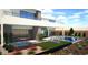 The backyard has a modern pool with an in-ground spa, fire pit, and sleek outdoor kitchen at 25 Canyon Bay Dr, Henderson, NV 89011