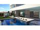 Modern pool area with built in outdoor kitchen, television, and patio at 25 Canyon Bay Dr, Henderson, NV 89011
