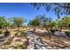 Tranquil neighborhood park featuring lush trees, walking trails, and well-maintained desert landscaping at 2017 Slow Wind St, Las Vegas, NV 89134