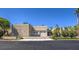 Contemporary house exterior with a four-car garage, desert landscaping, and a circular driveway at 2017 Slow Wind St, Las Vegas, NV 89134