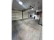 Spacious four-car garage with painted concrete floors and multiple overhead lights at 2017 Slow Wind St, Las Vegas, NV 89134