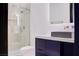 Modern bathroom featuring a glass-enclosed shower, black vanity, and brushed gold plumbing fixtures at 8780 Haven St, Las Vegas, NV 89123