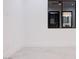 Minimalist bedroom showcases tile floors, clean white walls, and a dark framed window reflecting a chandelier at 8780 Haven St, Las Vegas, NV 89123