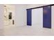 Bedroom featuring an ensuite bathroom with a glass-enclosed shower and tub area, plus blue sliding doors at 8780 Haven St, Las Vegas, NV 89123