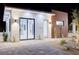 Modern exterior featuring a combination of stucco and wood accents, with stone landscaping at 8780 Haven St, Las Vegas, NV 89123