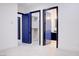 Bright hallway with contrasting blue doors leading to walk-in closet and modern bathroom at 8780 Haven St, Las Vegas, NV 89123