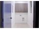 Neat laundry room area including overhead cabinets and access door at 8780 Haven St, Las Vegas, NV 89123
