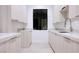 Well-lit laundry room with modern cabinetry, granite countertops, stainless steel faucet, and a black framed window at 8780 Haven St, Las Vegas, NV 89123