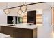 Modern living room with an open floor plan, large island, fireplace, and unique lighting at 8780 Haven St, Las Vegas, NV 89123