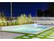 Backyard view showcasing a refreshing pool surrounded by lush greenery and modern design at 8780 Haven St, Las Vegas, NV 89123