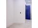 Bright room featuring tile floors, baseboards, and a modern blue door at 8780 Haven St, Las Vegas, NV 89123