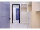 Bright walk-in closet featuring custom built-ins, drawers, shelving, and stylish gray tile flooring at 8780 Haven St, Las Vegas, NV 89123
