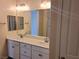 Double vanity bathroom with updated fixtures and a large mirror at 4761 E Sandalwood Dr, Pahrump, NV 89061