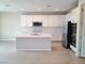 Modern kitchen with white cabinets and island at 4761 E Sandalwood Dr, Pahrump, NV 89061