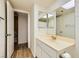Bathroom featuring a single sink vanity, tri-fold mirror, and open storage space at 5701 Pearldrop Ave, Las Vegas, NV 89107