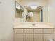 Bathroom featuring a large mirror, single sink vanity, and shower-tub combo with a skylight above at 5701 Pearldrop Ave, Las Vegas, NV 89107