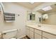 Bright bathroom with a single sink vanity, large mirror, and shower-tub combo with neutral tones at 5701 Pearldrop Ave, Las Vegas, NV 89107