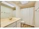 Bathroom featuring a single sink vanity, mirror, and shower with a white curtain at 5701 Pearldrop Ave, Las Vegas, NV 89107