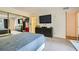 Bedroom with carpet, large TV, generous closet space, and access to en-suite bathroom at 5701 Pearldrop Ave, Las Vegas, NV 89107