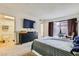 Bedroom with carpet, private patio, large TV, and en-suite bathroom at 5701 Pearldrop Ave, Las Vegas, NV 89107
