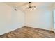 Dining room featuring modern lighting, wood floors, and neutral wall color at 5701 Pearldrop Ave, Las Vegas, NV 89107