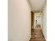 Hallway with wood-look flooring, leading to other rooms and offering a built-in cabinet at 5701 Pearldrop Ave, Las Vegas, NV 89107