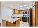 Efficient kitchen featuring light countertops, stainless steel appliances, and wood cabinetry at 5701 Pearldrop Ave, Las Vegas, NV 89107