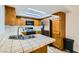 Efficient kitchen featuring light countertops, stainless steel appliances, and wood cabinetry at 5701 Pearldrop Ave, Las Vegas, NV 89107