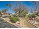 Beautiful landscaping with mature trees, lush shrubs, and charming walkway at 5701 Pearldrop Ave, Las Vegas, NV 89107
