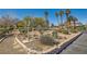 Beautiful landscaping with mature trees, lush shrubs, and charming features at 5701 Pearldrop Ave, Las Vegas, NV 89107
