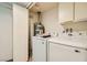 Laundry room featuring modern washer, dryer and water heater and built in storage at 5701 Pearldrop Ave, Las Vegas, NV 89107