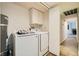 Laundry room featuring modern washer, dryer and water heater and built in storage at 5701 Pearldrop Ave, Las Vegas, NV 89107