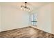 Bright living room with wood flooring, light fixture, and a large window at 5701 Pearldrop Ave, Las Vegas, NV 89107
