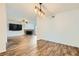 Bright living room with wood flooring, modern light fixture, and view of fireplace at 5701 Pearldrop Ave, Las Vegas, NV 89107