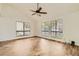 Bright living room featuring modern flooring, a ceiling fan, and large windows offering an abundance of natural light at 5701 Pearldrop Ave, Las Vegas, NV 89107