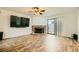 Spacious living room with laminate flooring, a brick fireplace, and sliding glass doors at 5701 Pearldrop Ave, Las Vegas, NV 89107