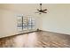 Spacious living room featuring light walls, modern flooring, a ceiling fan, and large windows at 5701 Pearldrop Ave, Las Vegas, NV 89107
