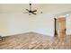 Bright living room with modern flooring, ceiling fan, and access to an outdoor patio through sliding glass doors at 5701 Pearldrop Ave, Las Vegas, NV 89107
