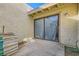 Private patio with stucco walls, sliding glass doors, and stacked boxes at 5701 Pearldrop Ave, Las Vegas, NV 89107