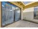 Private patio with stucco walls, sliding glass doors, and a hose at 5701 Pearldrop Ave, Las Vegas, NV 89107