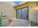 Back patio surrounded by stucco wall and features sliding glass doors at 5701 Pearldrop Ave, Las Vegas, NV 89107