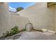 Private patio with stucco walls, small garden area, and stacked boxes at 5701 Pearldrop Ave, Las Vegas, NV 89107