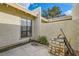 Private patio with stucco walls, small garden area, and boxes at 5701 Pearldrop Ave, Las Vegas, NV 89107