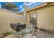 Private patio featuring a dining set and cozy lounge seating, enhanced by natural light and neutral tones at 5701 Pearldrop Ave, Las Vegas, NV 89107