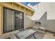 Comfortable patio with a glass table dining set, sliding door access, and pleasant outdoor ambiance at 5701 Pearldrop Ave, Las Vegas, NV 89107