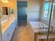 Luxurious bathroom with double vanity and soaking tub at 9902 Belikove Manor Ave, Las Vegas, NV 89178